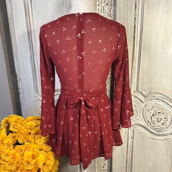 Ruby Red Ruffled Sheer Romper with Plunge Neckline and Statement Sleeves - Picture 8 of 11